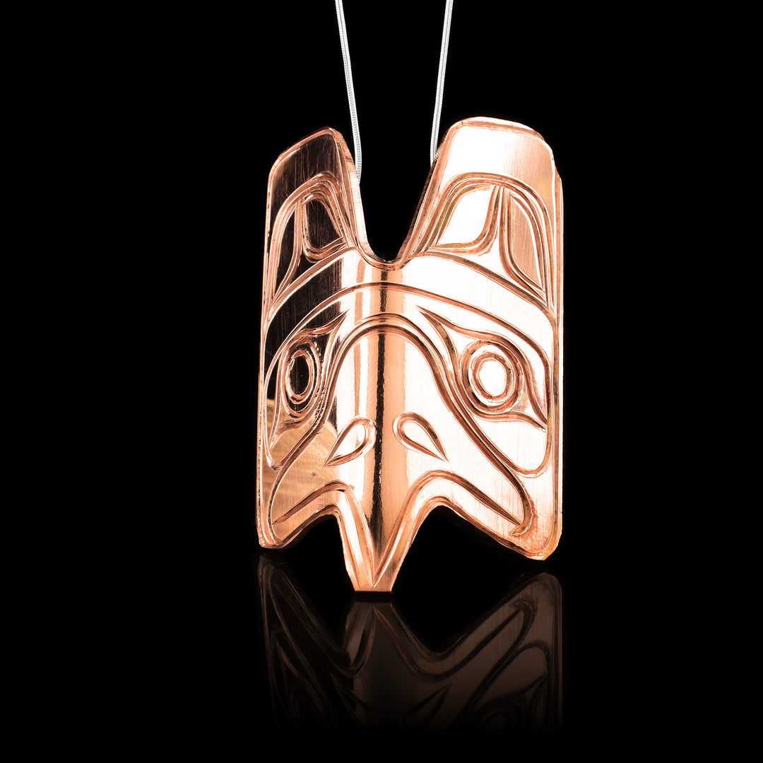 The copper pendant is slightly folded for a 3D effect and the pendant is carved into the legend of the Eagle with indigenous detail of the Eagles face and beak. 