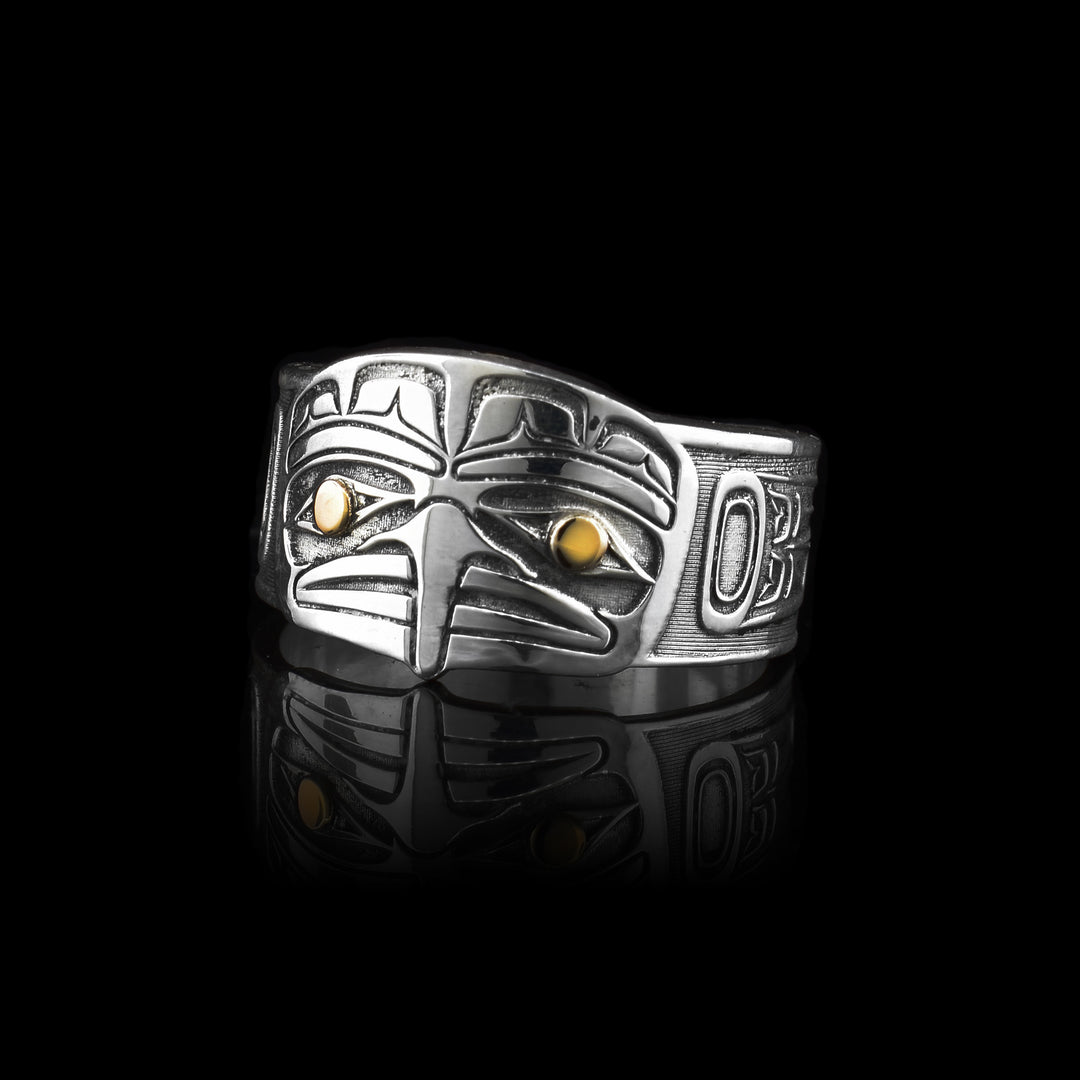 Eagle Face Silver & Gold Ring. Made with sterling silver and 14k gold. The eagle face is carved into the front of the ring with golden eyes.