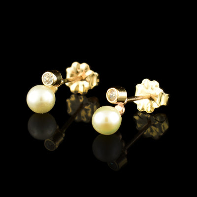 These gold cubic zirconia earrings have freshwater pearls attached under small, cubic zirconia studs. The Cubic zirconia are held with 4K gold filled material as well as the  pearls.