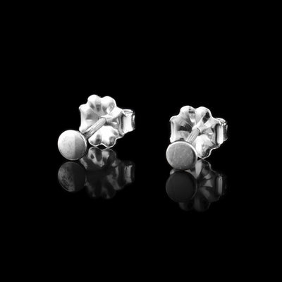 These sterling silver circle stud earrings have very small, circle studs. The studs are made from sterling silver and there are flower shaped earring backs.