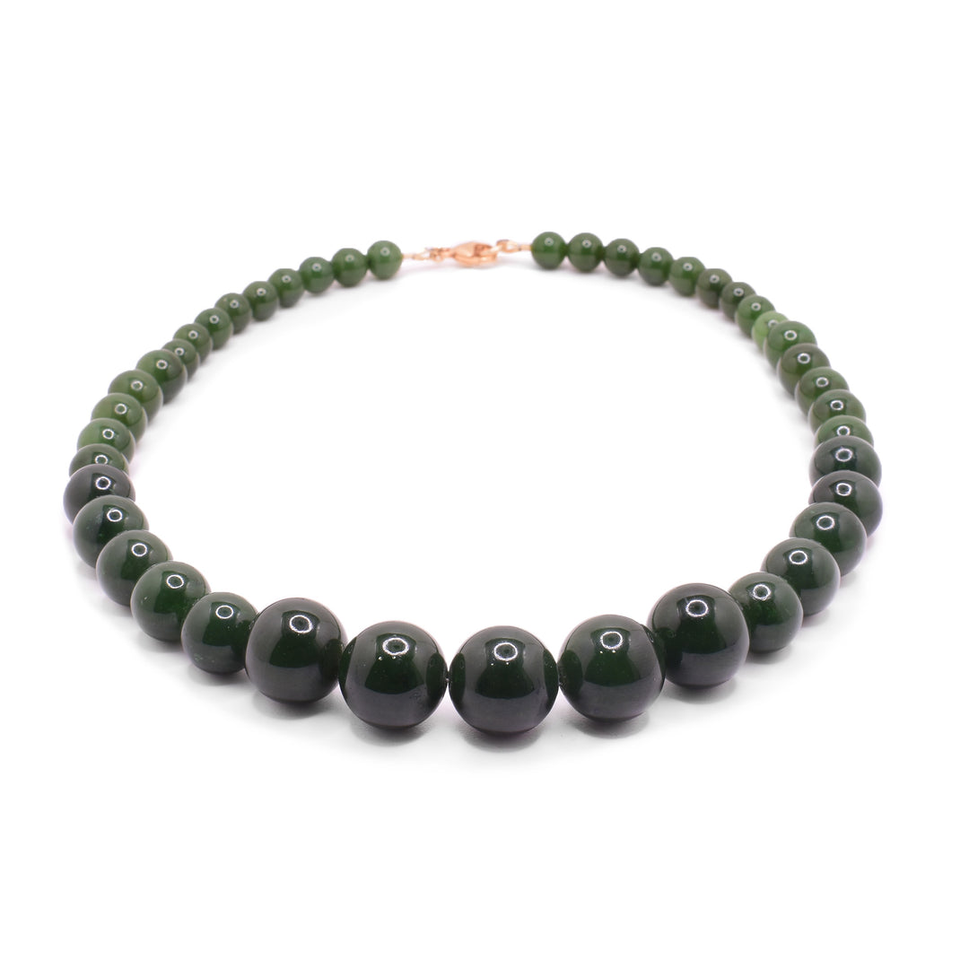 Beaded jade with gold necklace has different sized, sphere shaped jade beads with small, gold filled beads between the gemstone beads. The jade beads get uniformly  larger as the get closer to the center.