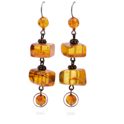Dangle drop earrings made of Baltic amber and brass. Titanium hooks. By Honica.