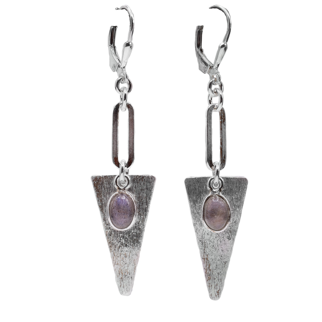 These dangling labradorite earrings have a long chain link hanging from the hooks and an upside down triangle piece. They are made from sterling silver and the surface is textured. There are oval shaped labradorite gems dangling in front of the triangle hangs.