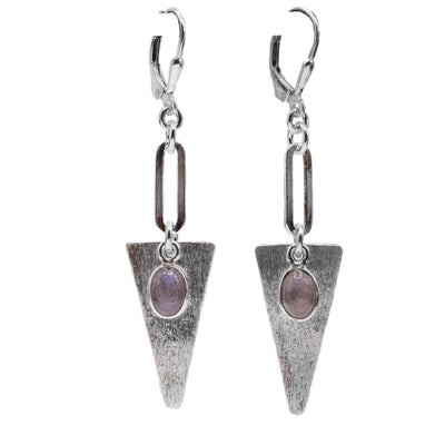 These dangling labradorite earrings have a long chain link hanging from the hooks and an upside down triangle piece. They are made from sterling silver and the surface is textured. There are oval shaped labradorite gems dangling in front of the triangle hangs.