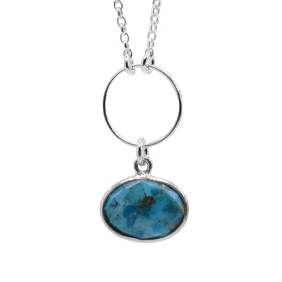 This turquoise necklace is made from sterling silver and genuine turquoise gemstone. The pendant is oval shaped and has a stunning turquoise gem that dangles from a circle shaped silver hoop.