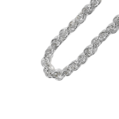 Hand-cut and shaped sterling silver rings are woven together to create a necklace in Lisa Ridout’s “twist” pattern. Can be worn with or without a pendant.