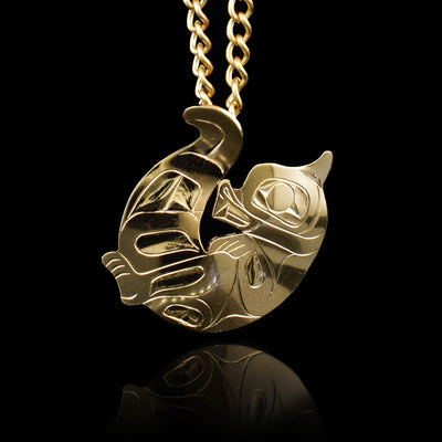 This Otter pendant is made using solid 14K gold and has a round shape and a hidden bail in the back. The piece is shaped like the Otter curled up on its back and has carvings on the surface of it depicting the Otter.