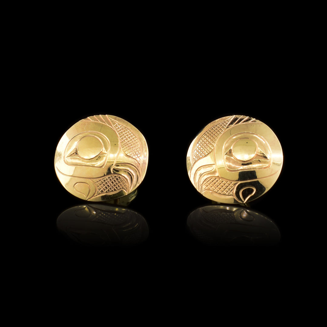 These 14K gold stud earrings have circular surfaces with depictions of the Owl carved into them.