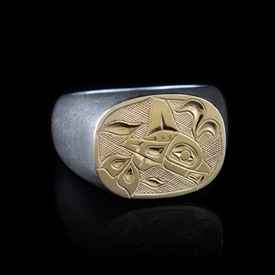 This sterling silver signet ring has 14K gold covering the entire signet. On the signet there is a depiction of the Orca carved into the surface.