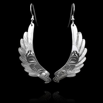 These flying Eagle earrings are made from sterling silver have long hangs. There is a depiction of the head of the Eagle at the bottom and its wings are curved and extend to the rest of the piece.