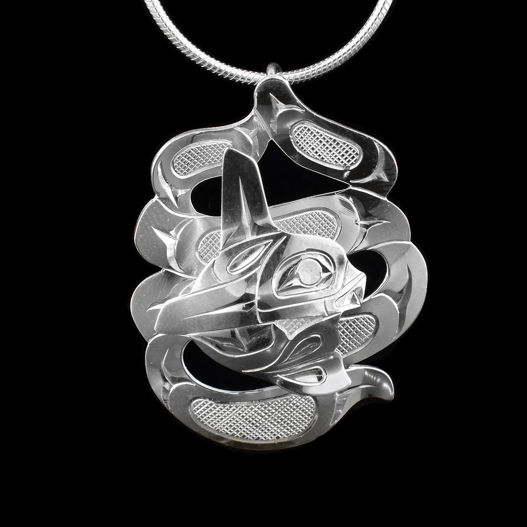 This stunning Orca pendant is made from sterling silver. There are two parts of this piece; the first is a large, carved and cutout piece depicting the waves, and the second one is a carved piece depicting the Orca that is set in the middle on the piece.