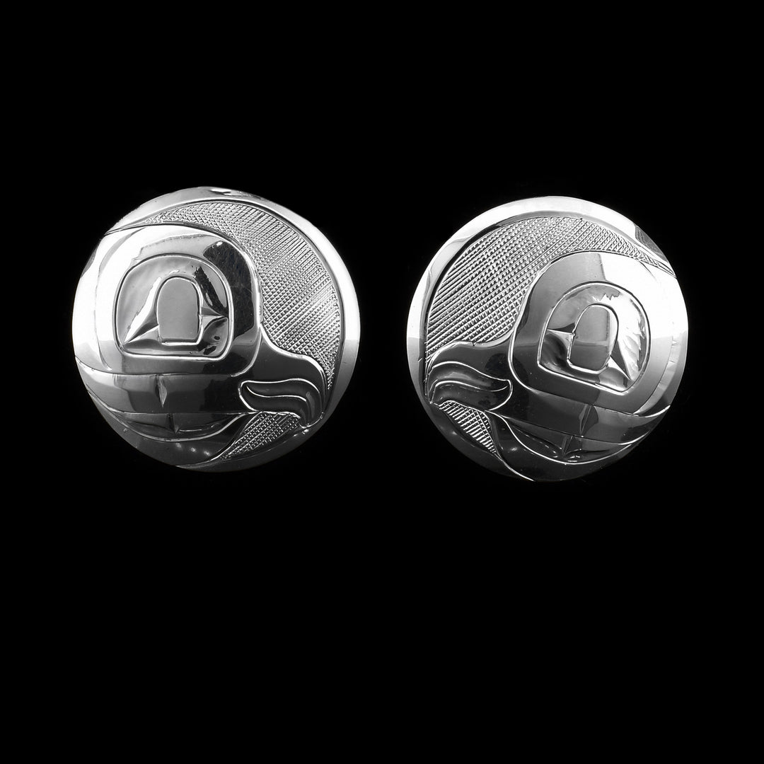 These circle stud earrings are made using sterling silver and have depictions of the head of the Owl carved into the surface of them. The designs show the side profile of the Legend.
