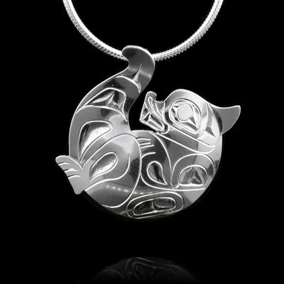 This Otter pendant is made from sterling silver and is shaped liek an otter curled up on his back. There are gorgeous carvings on the surface of the piece depicting the Otter.