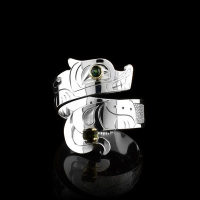 This Wolf ring has a sterling silver wide band that wraps around the finger twice. The top band  is carved to depict the head of the Wolf and the bottom one depicts its tail. There is a tourmaline gem that is embedded into the eye of the legend.