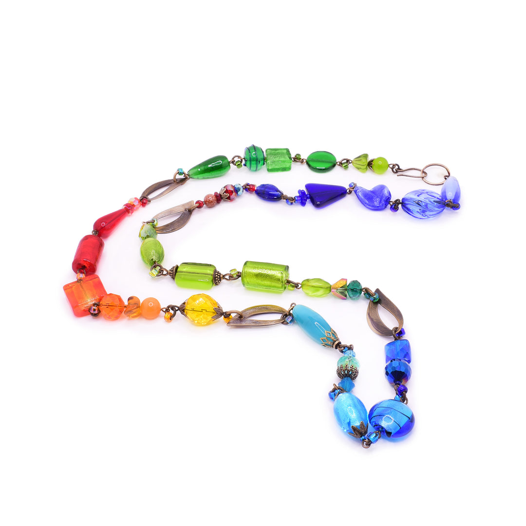 This Honica Rainbow necklace. Handcrafted with Serpentine, Goldstone, and Swarovski Crystals on antique brass, it is a colorful masterpiece.