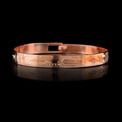 This Hummingbird and Orca bracelet ahs a single, thin and coper and with a clasp in the back. There are depictions of the Hummingbird and the Orca carved into the surface of the band.