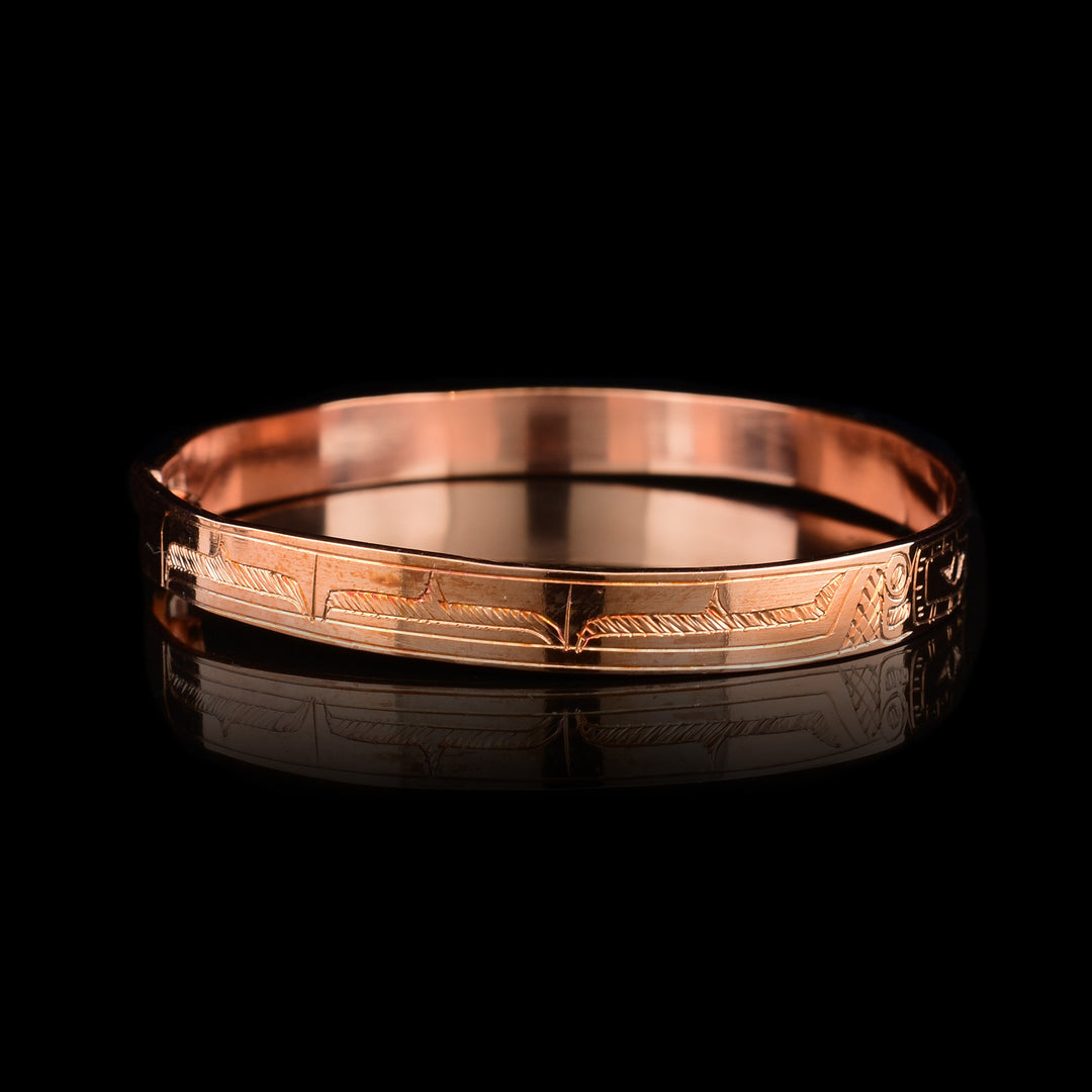 This dainty Hummingbird bracelet has a single, thin copper band with a clasp in the back. There are depictions of the Hummingbird carved into the band.