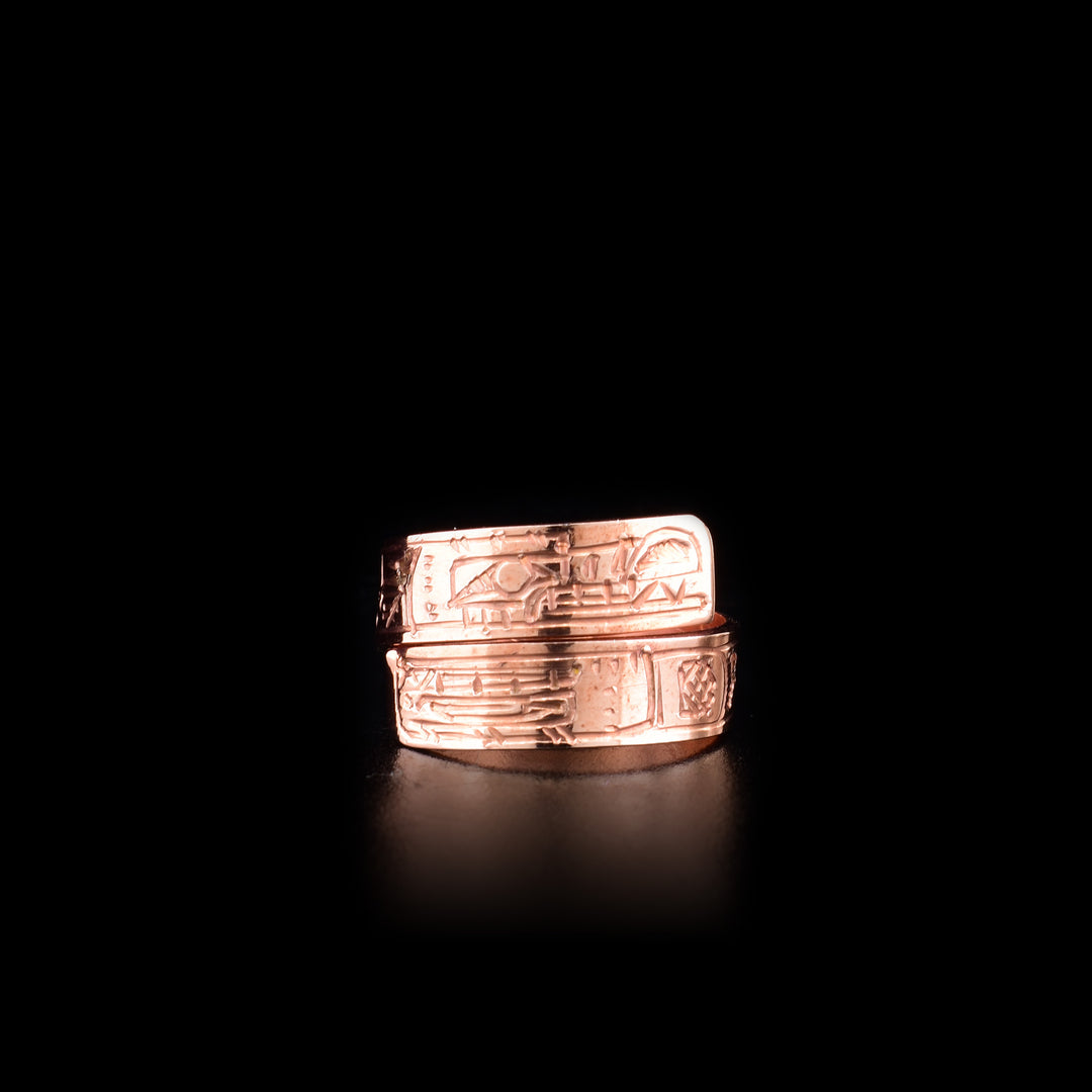 This copper ring has a thin band that wraps around the finger twice. There are depictions of the Wolf and the Orca carved into the surface of the band.