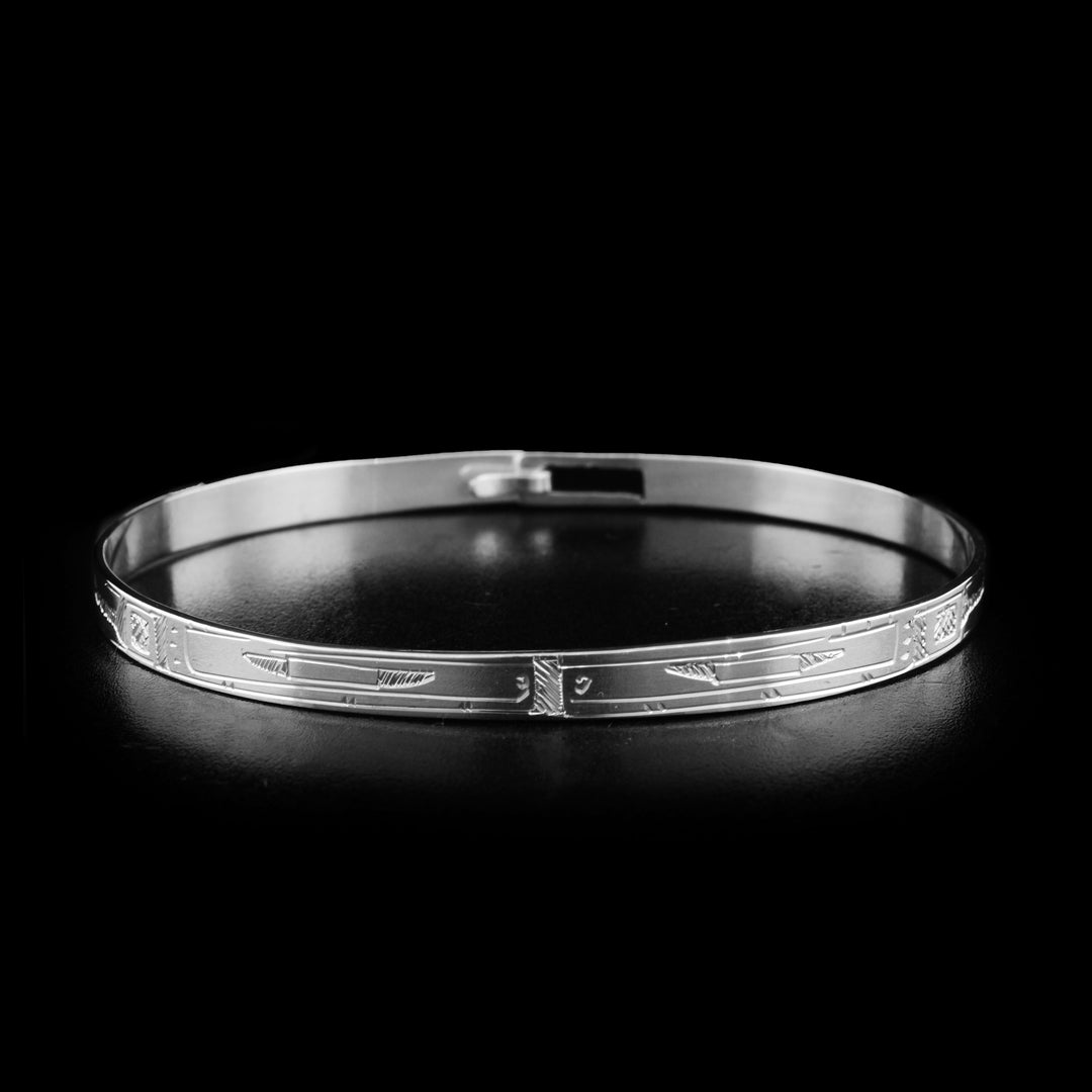 This sterling silver Orca bracelet depicts two Orca heads facing each other. The bodies of the Orcas are depicted on the rest of the bracelet. There is a clasp in the back.