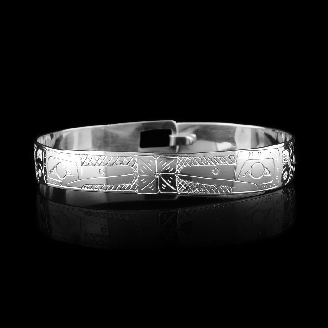 This Hummingbird and flower bracelet has a single, sterling silver band with a clasp in the back. There are two depictions of the Hummingbird carved into the band. The legends are depicted facing each other and there are flowers carved in the center of it.
