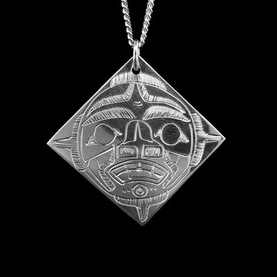 This unique Moon pendant is made from sterling silver and has a symmetric diamond shape to it. There is a depiction of Moon that has been intricately carved into the surface of the piece.