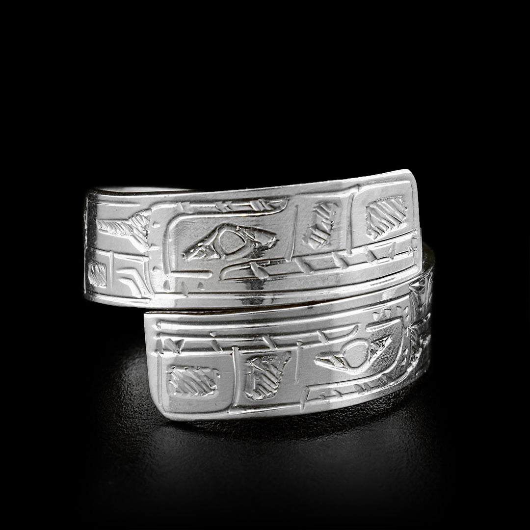The two ends of this sterling silver wrap around ring overlap in the front. Both ends of the ring have a face of the Bear carved on it.