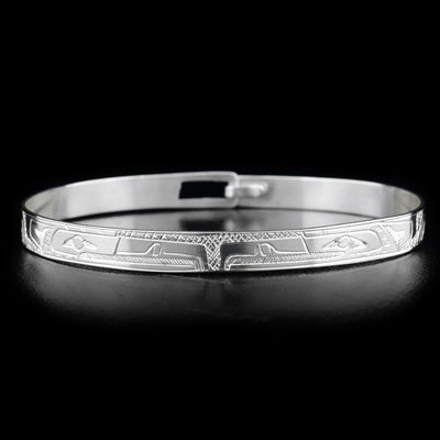 This sterling silver clasp bracelet has a thin band with two depictions of the Eagle carved into the surface of it.