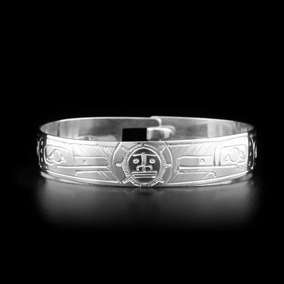 This sterling silver clasp bracelet has two depictions of the Hummingbird and a depiction of the Sun carved into the band. The Hummingbirds are depicted facing the Sun and there is a clasp at the back of the bracelet.