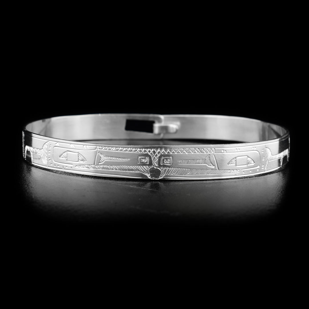 This sterling silver clasp bracelet has two depictions of the Raven carved into the surface of the band. The Ravens are depicted facing each other at the top of the band.
