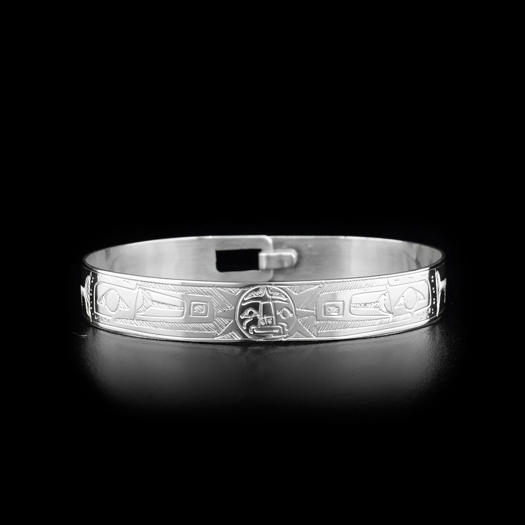 This Raven and Sun bracelet is made from sterling silver and there is a clasp in the back. There are two depictions of the Raven and a depiction of the Sun carved into the band.