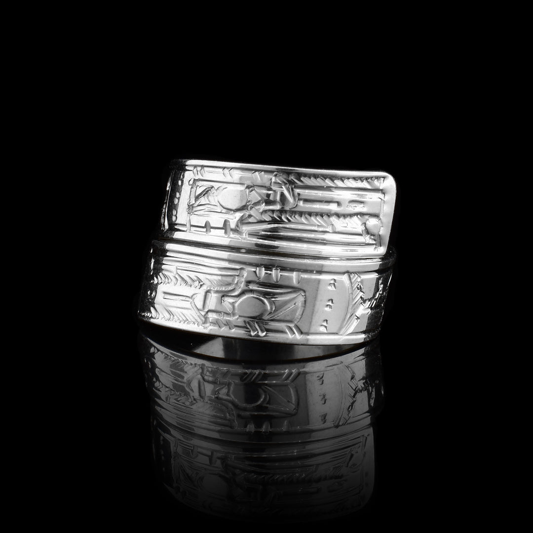 This sterling silver Raven ring has a band that wraps around the finger twice. There is a depiction of the Raven carved into the surface of the band.