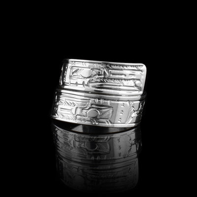 This sterling silver Raven ring has a band that wraps around the finger twice. There is a depiction of the Raven carved into the surface of the band.