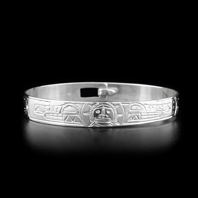 This silver clasp bracelet has two depictions of the Wolf and a depiction of the Sun. The Wolves are depicted facing the Sun at the top of the band.