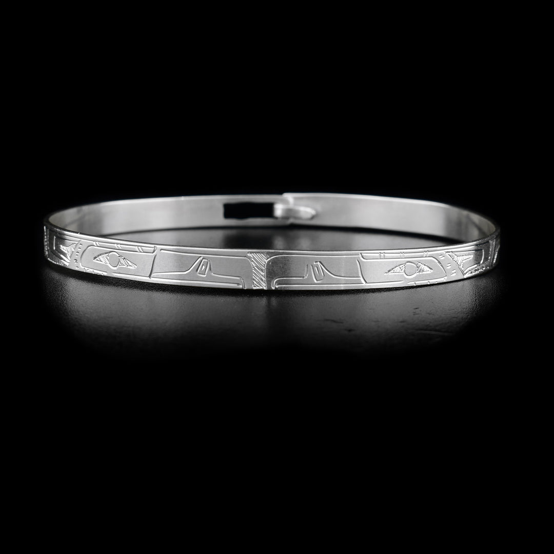 This sterling silver Eagle bracelet depicts two Eagle heads facing eachother in the middle of the bracelet. The bEagle bodies are depicted on the rest of the bracelet. There is a clasp in the back.