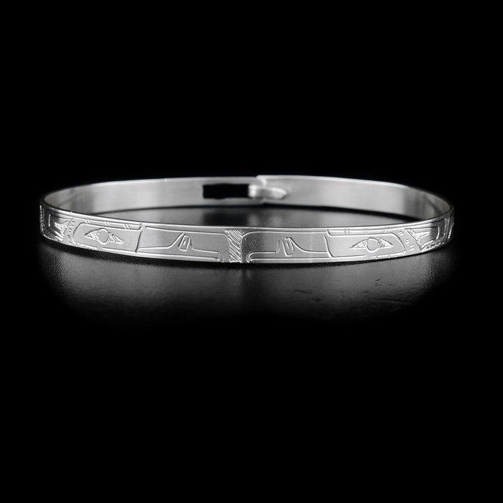 This sterling silver Eagle bracelet depicts two Eagle heads facing eachother in the middle of the bracelet. The bEagle bodies are depicted on the rest of the bracelet. There is a clasp in the back.