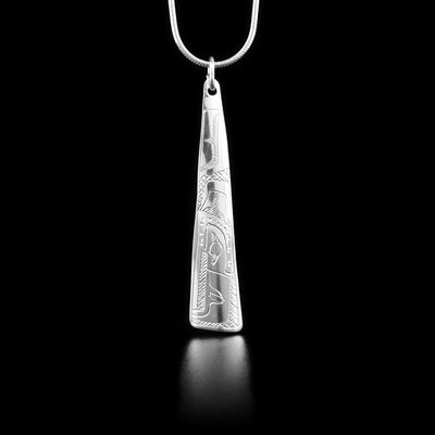 This sterling silver pendant is long, thin and triangular. There is a depiction of the Eagle carved into it.