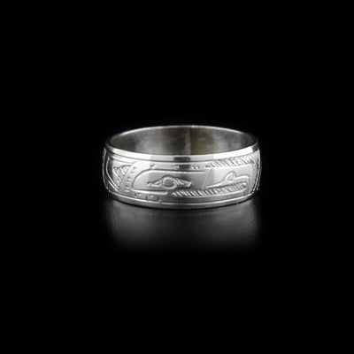 This silver band ring is made from sterling silver and has a depiction of the Eagle carved into it.