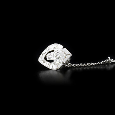 This piece includes a sterling silver tie tack that is shaped and carved like the Eagle attached to a small chain.