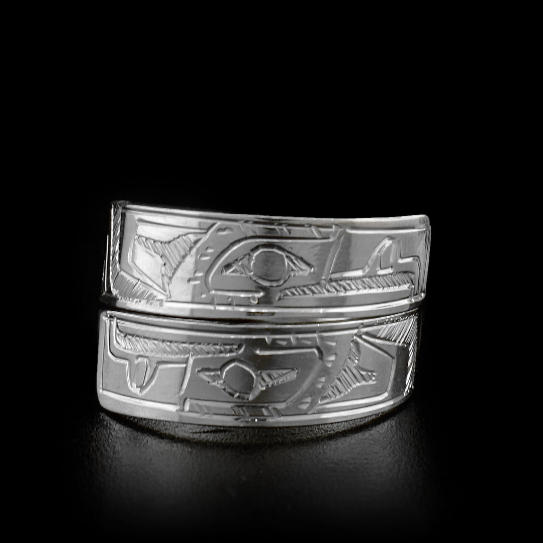 The two ends of this sterling silver wrap around ring overlap in the front. Both ends of the ring have a face of the Eagle carved on it.