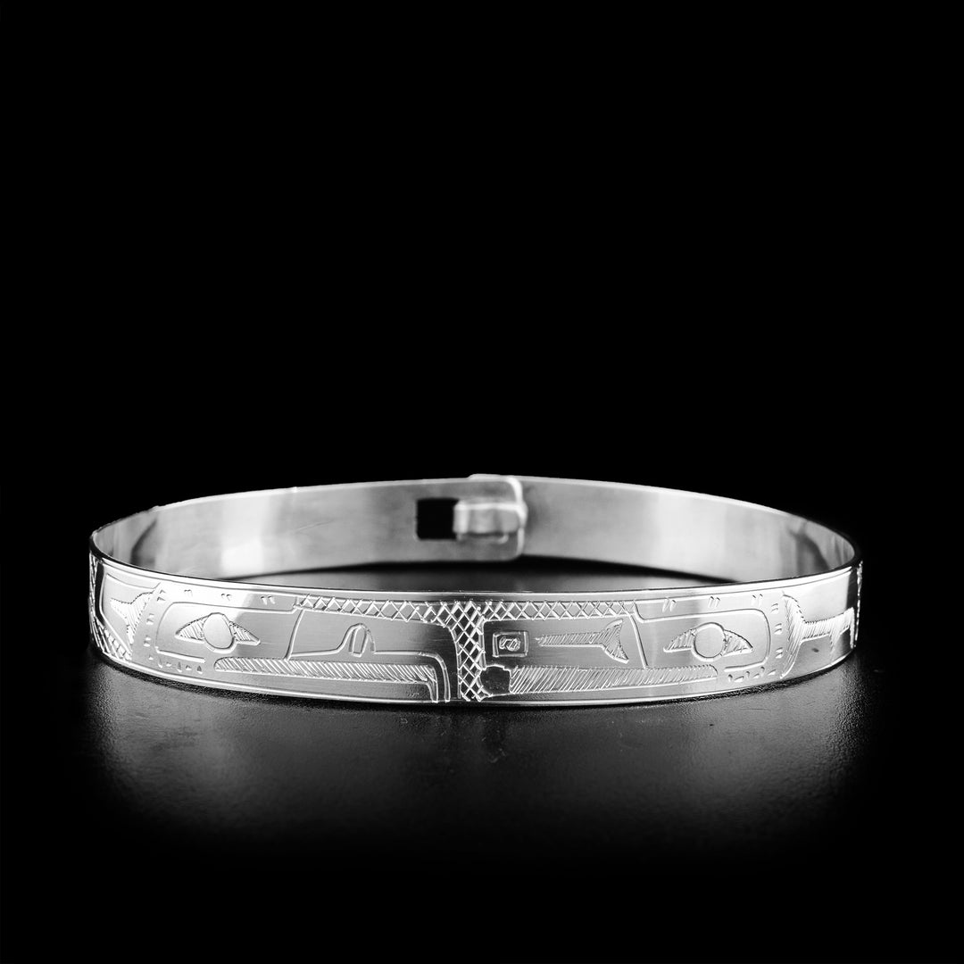 This sterling silver Eagle and Raven bracelet depicts the Eagle and the Raven with the Sun in his mouth. The bodies of the birds are engraved all around the bracelet.