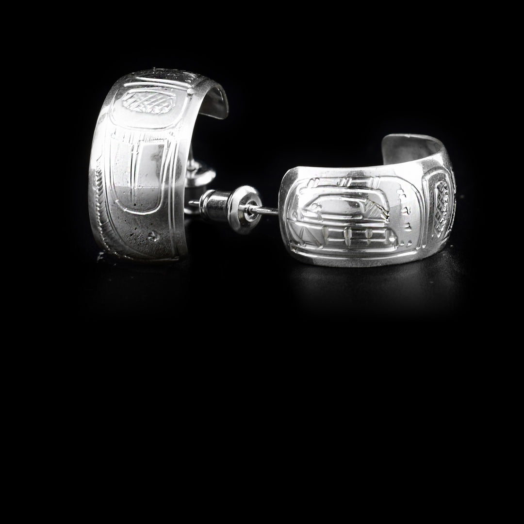 These sterling silver earrings are shaped like incomplete hoops and depict the face and body of the Orca.