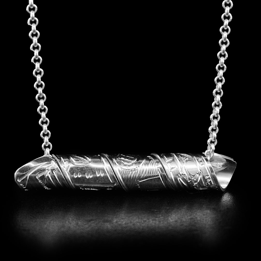This Thunderbird spiral pendant is made out of a sterling silver strip which has the face and body of the Thunderbird carved on it and then coiled into a spiral.