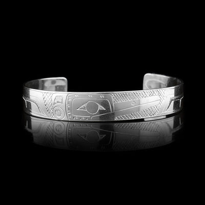 This sterling silver cuff bracelet has a thin band with a depiction of the Hummingbird carved into the surface of it.