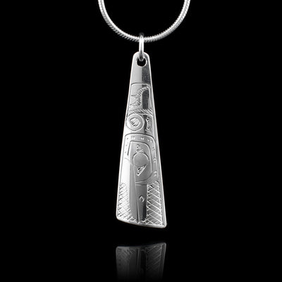 This sterling silver pendant is shaped like a triangle and there is a depiction of the Hummingbird carved into the surface of the pendant. 