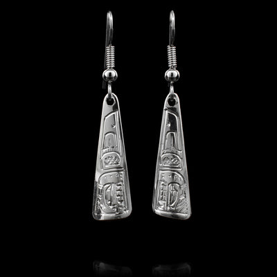 These dangling Orca earrings are made from sterling silver and have long, tapered hangs. There are designs carved into the surface of the hangs depicting the Orca.