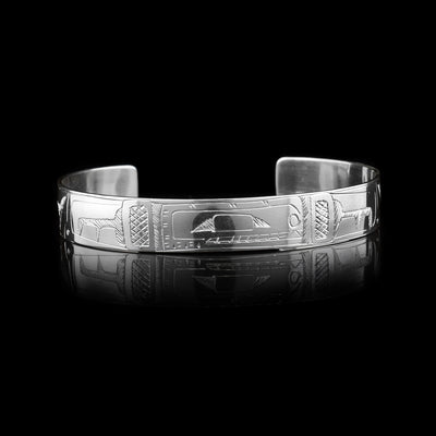 This sterling silver cuff bracelet has a single band with a depiction of the Orca carved into it.