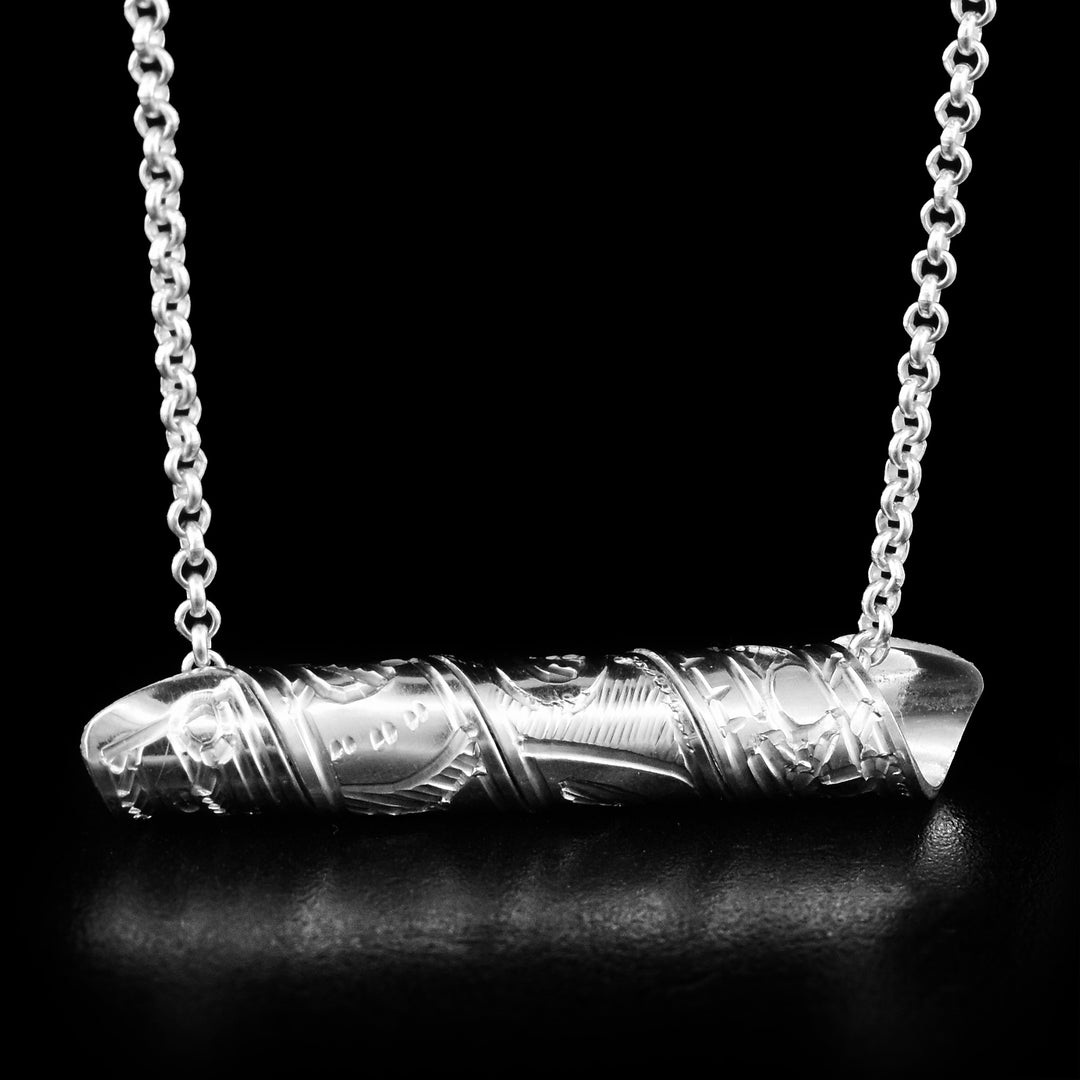 This sterling silver spiral pendant is made our of a strip of sterling silver. The strip of sterling silver depicts the head and body of the Raven. The strip is coiled into a spiral.