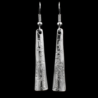 These long Raven earrings are made from sterling silver and have long hangs that taper out slightly at the end. There are depictions of the Raven that have been carved into the surface of the hangs.