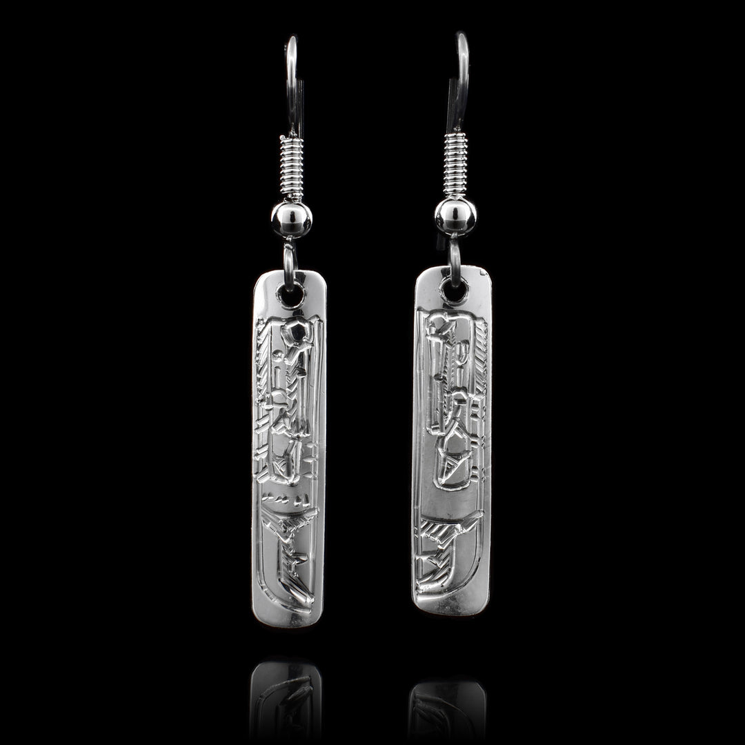 These sterling silver Raven earrings have rectangular hangs and there is a depiction of the Raven carved into them.