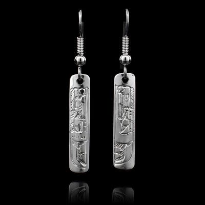 These sterling silver Raven earrings have rectangular hangs and there is a depiction of the Raven carved into them.